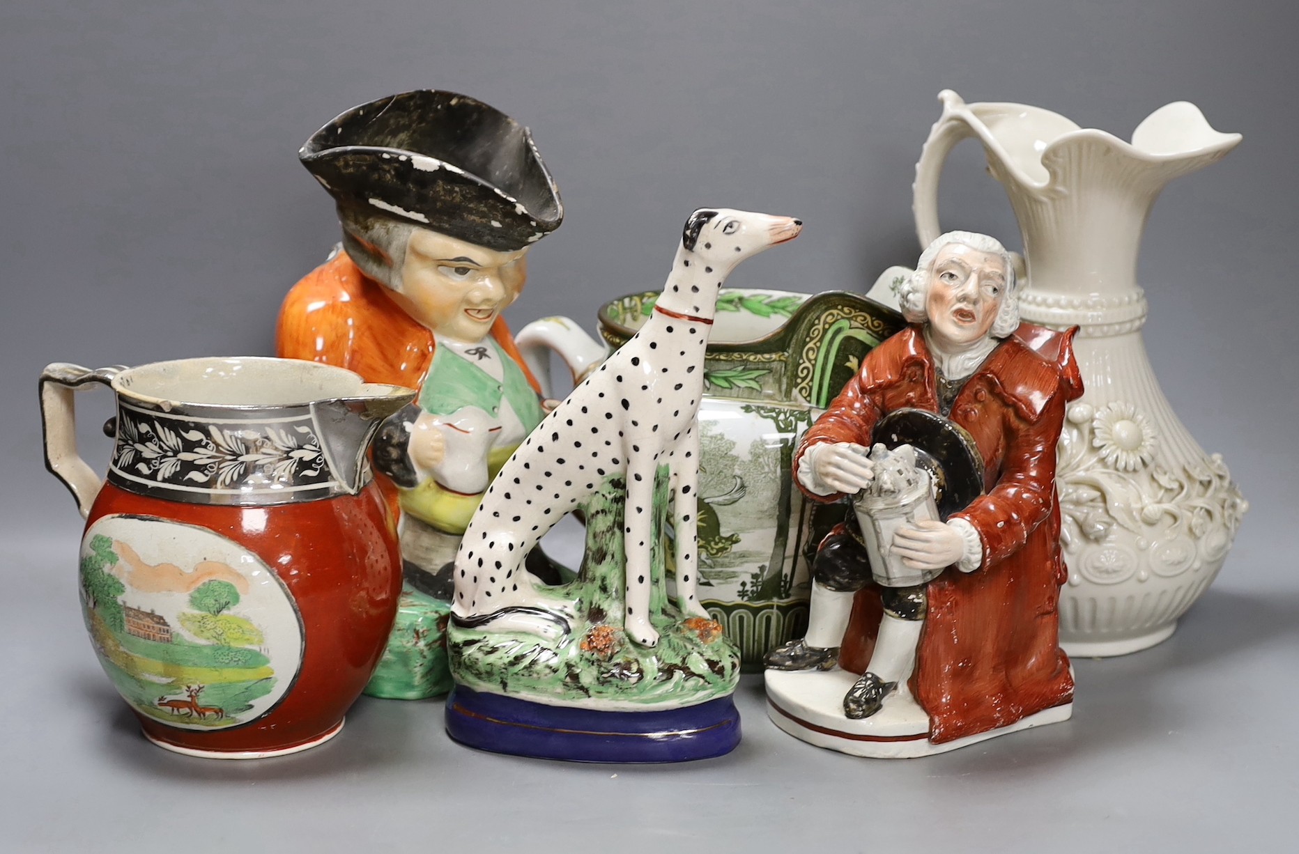 An early 19th century Staffordshire pearlware Night Watchman character jug, a Belleek ewer, a Staffordshire figure of a Dalmatian dog, a Royal Doulton jug and two other items, tallest 23cm (6)